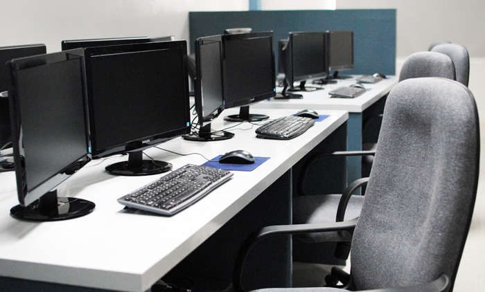 4 workstations at 2nd Office's open plan workspace showing wide desks, 2 monitors each station, and swivel office chairs