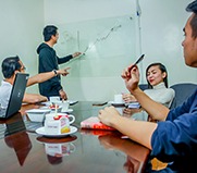 picture of employees working in a conference room